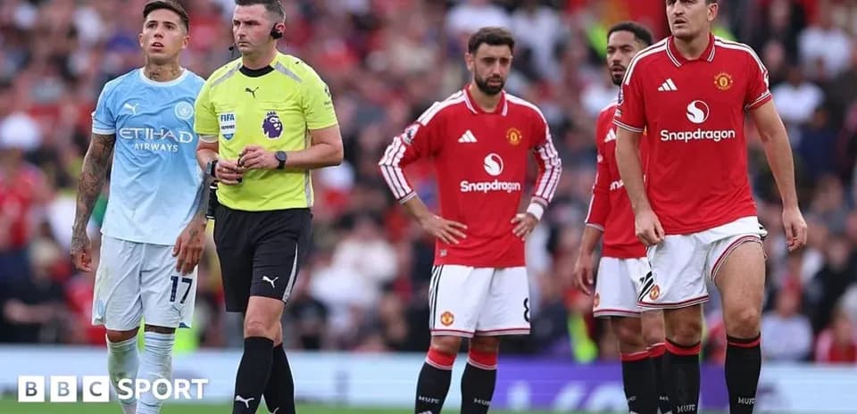 Players and referee during Manchester derby match