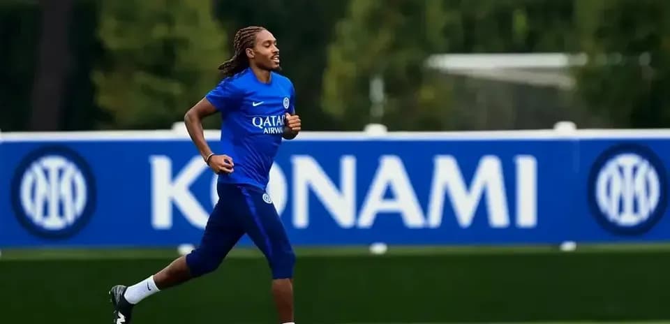 Player jogging on training pitch with team logo