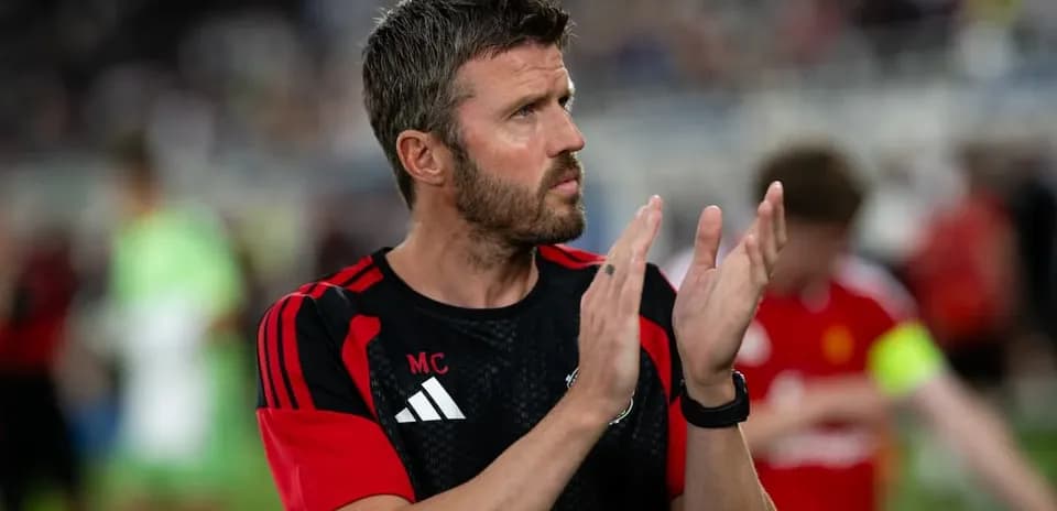 Coach clapping during post-match celebrations