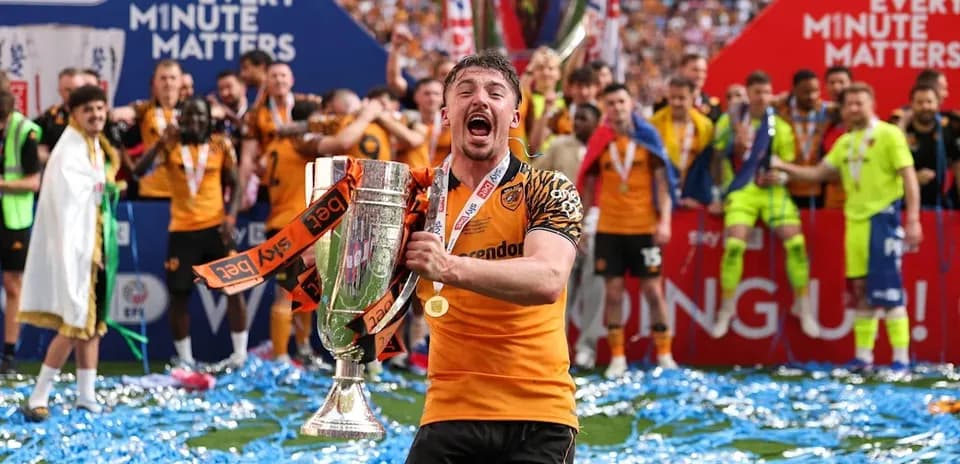 Player celebrating with trophy after championship victory