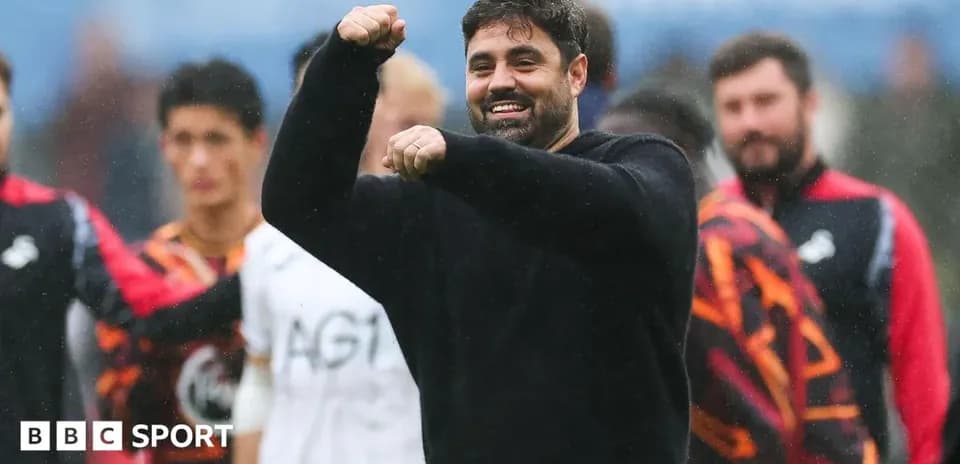 Coach celebrating with raised fist on the pitch