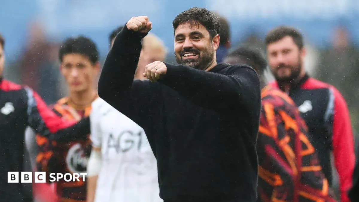Coach celebrating with raised fist on the pitch