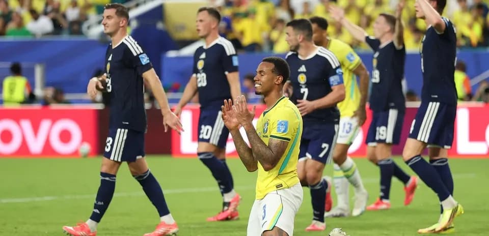 Brazilian player celebrating while Scottish players react