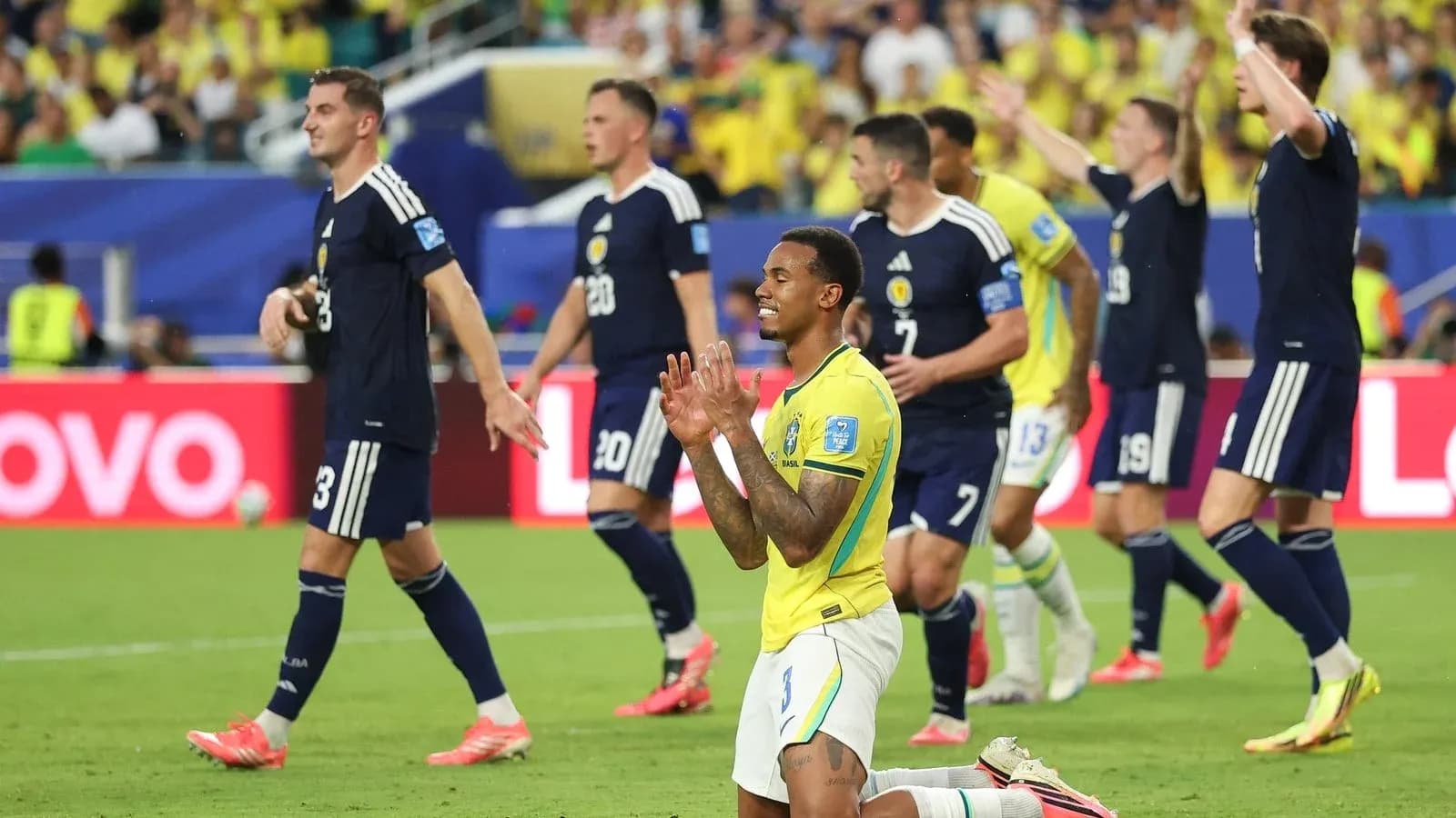 Brazilian player celebrating while Scottish players react