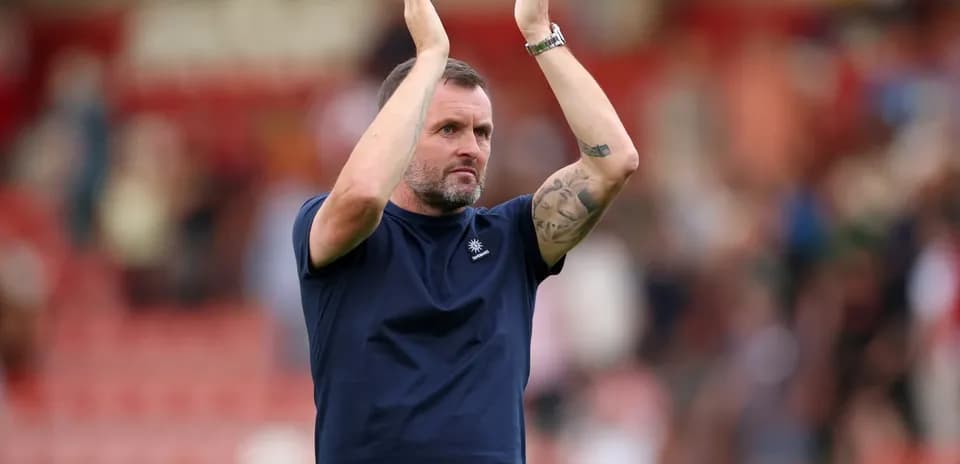 Coach applauding fans after the match