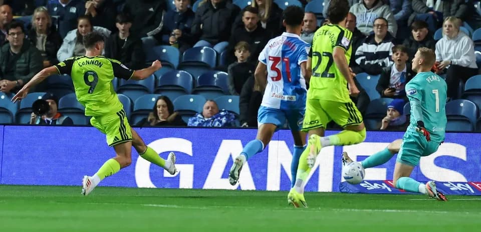 Player shooting on goal with goalkeeper approaching