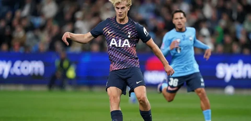 Player in Tottenham kit kicking ball during match