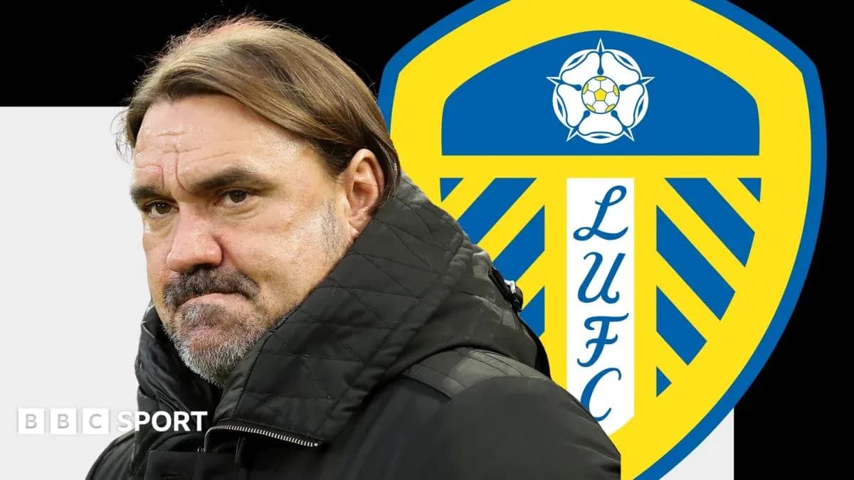 Manager in front of Leeds United club logo