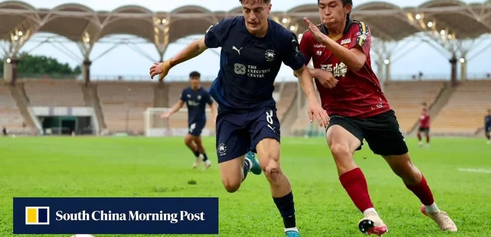 Player in blue jersey chasing ball, red player defending
