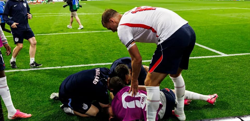 Players and staff attending to an injured teammate