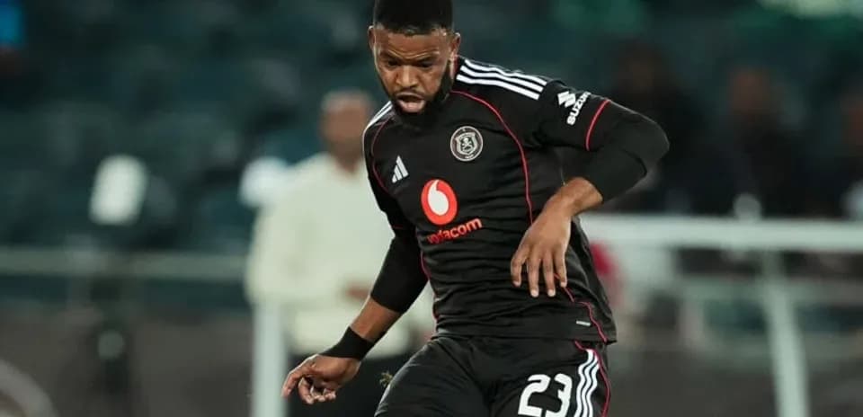 Player in black kit dribbling the ball during match