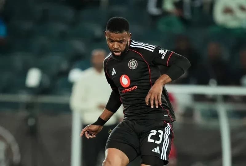 Player in black kit dribbling the ball during match