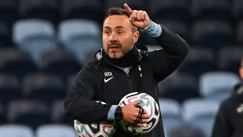 Coach giving instructions while holding footballs