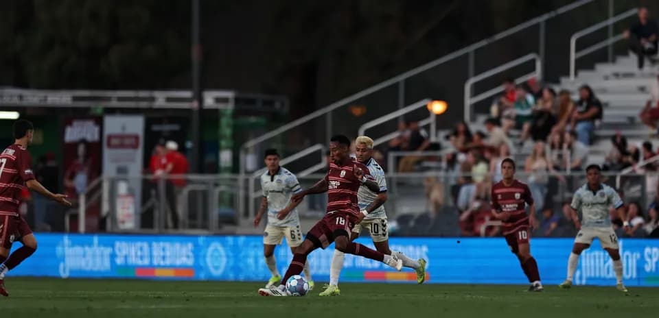 Players competing for the ball in USL Championship