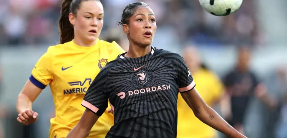 Players competing for the ball in NWSL match