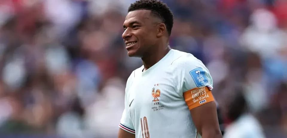Kylian Mbappé smiling in France national team kit