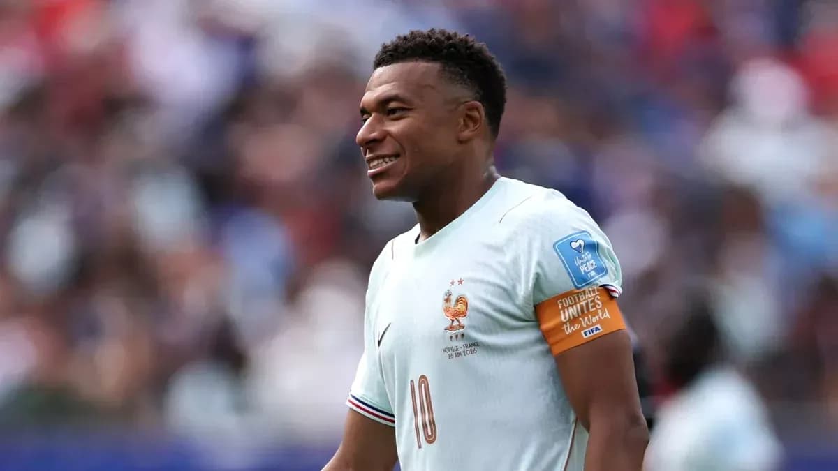 Kylian Mbappé smiling in France national team kit