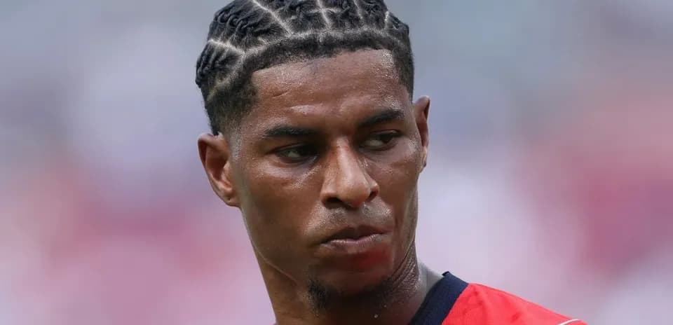 Player with braided hairstyle in red jersey