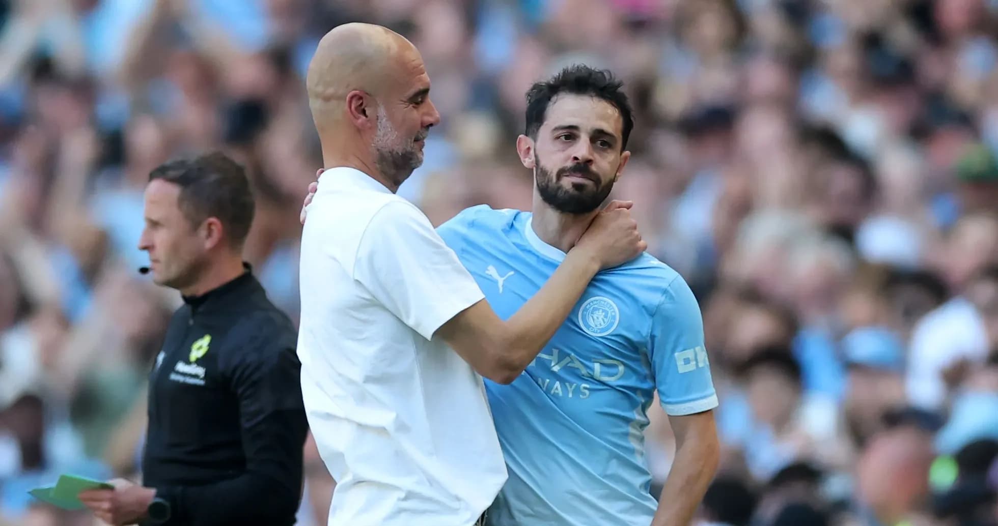 Manager embracing player during match substitution