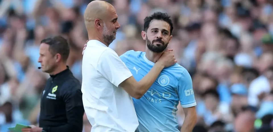 Manager embracing player during match substitution