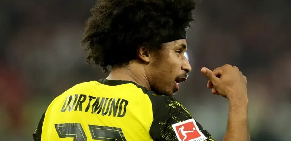 Player wearing Dortmund jersey celebrating on the field