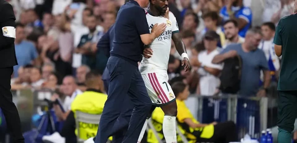 Coach advising player during match at stadium
