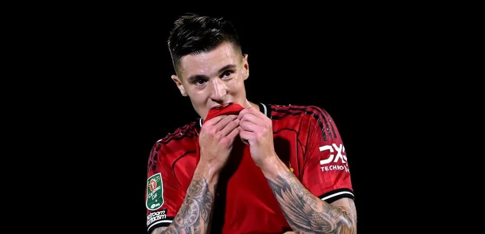 Player in red jersey biting shirt after match