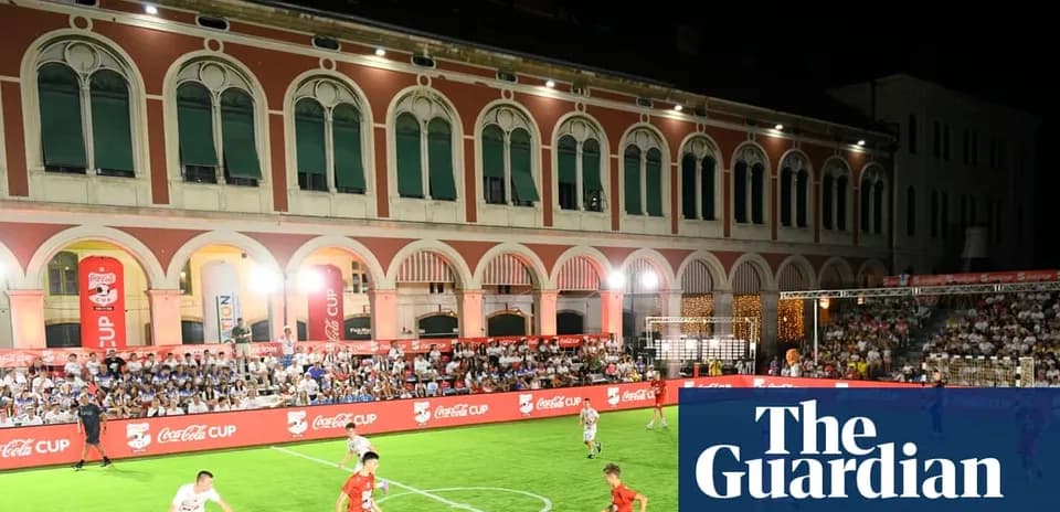 Players competing in Coca-Cola Cup match at night