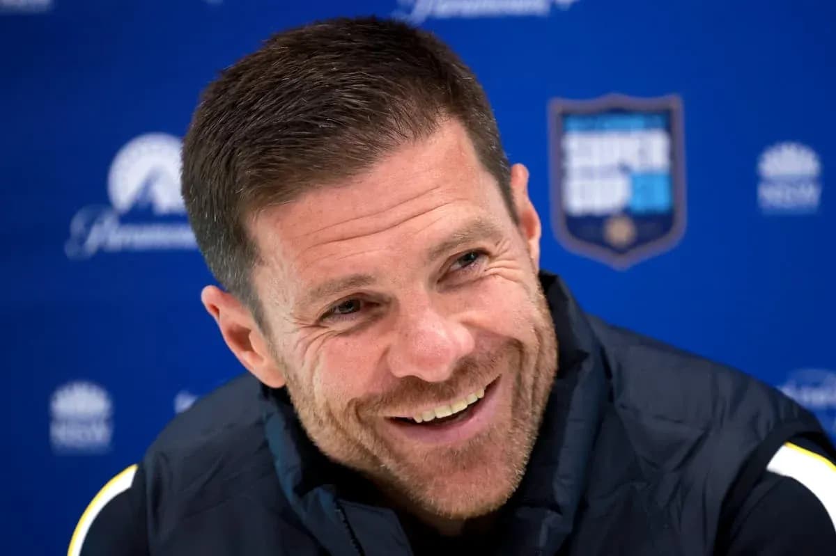Coach speaking at a press conference with backdrop