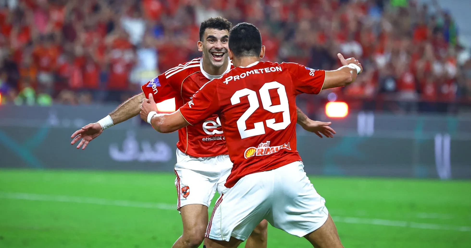 Players celebrating a goal on the field