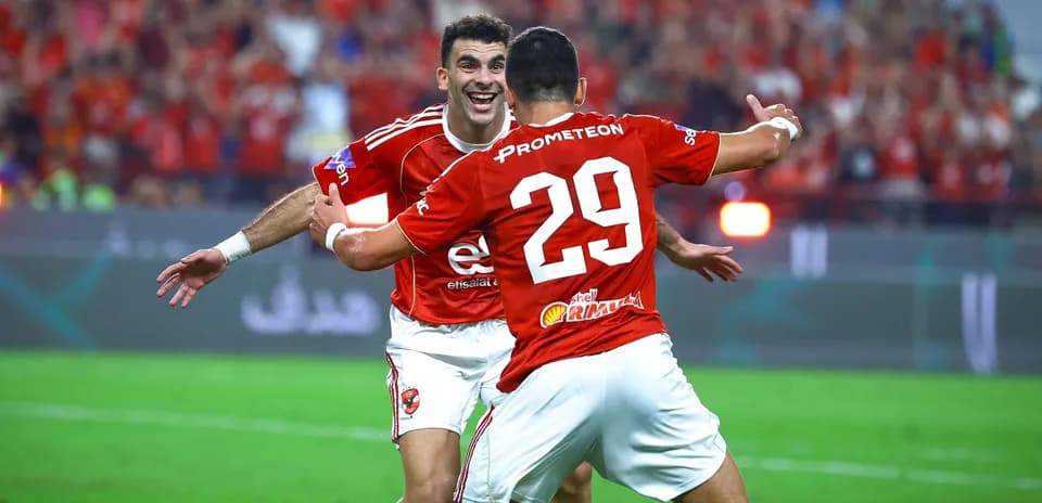 Players celebrating a goal on the field
