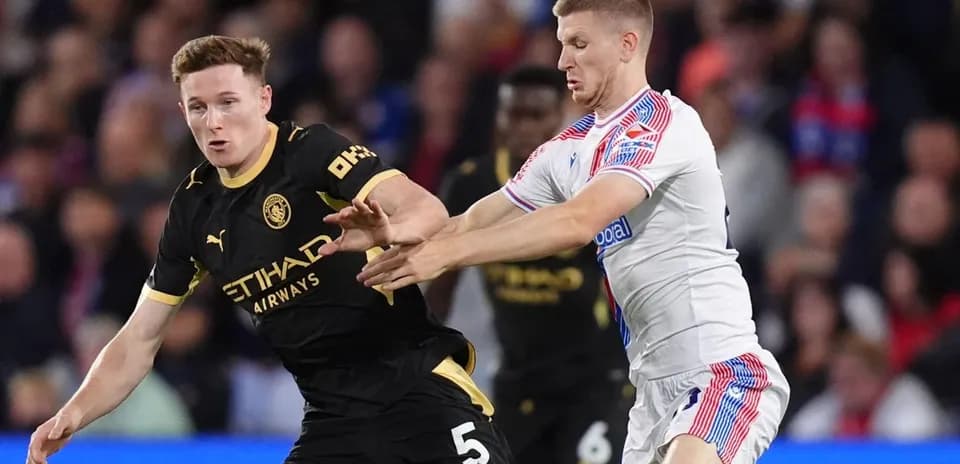 Players contesting possession during Premier League match