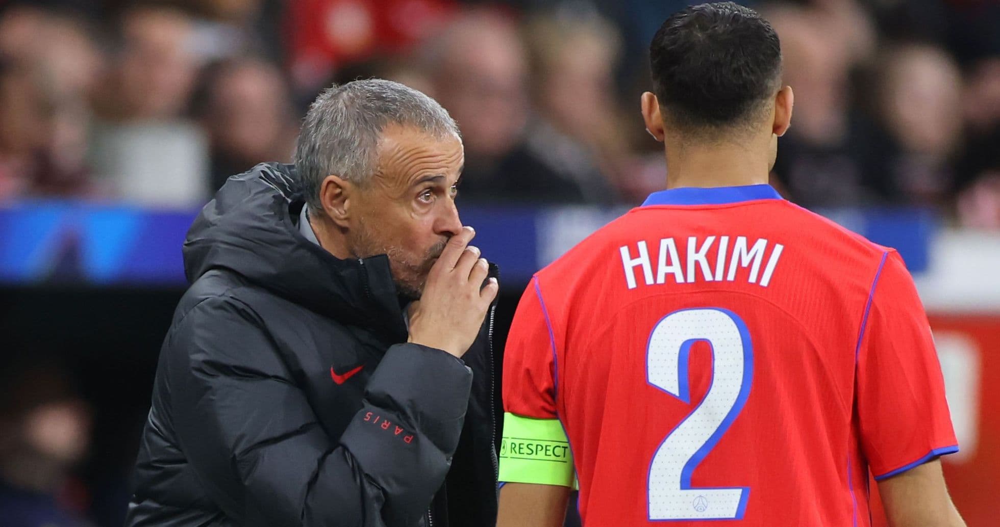 Coach discussing strategy with player Hakimi during match