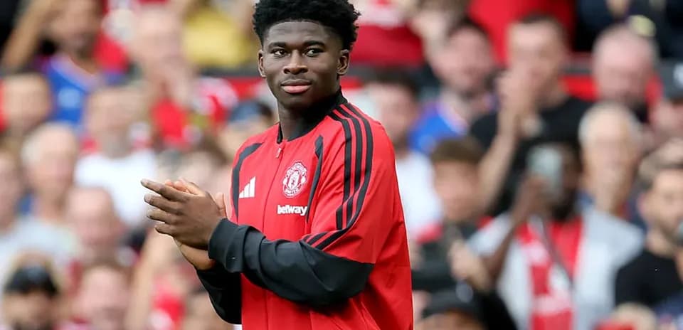 Player in Manchester United jersey acknowledging crowd
