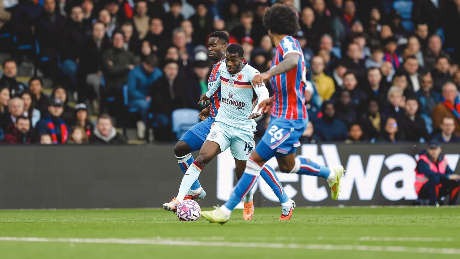 Brentford player dribbling against Crystal Palace