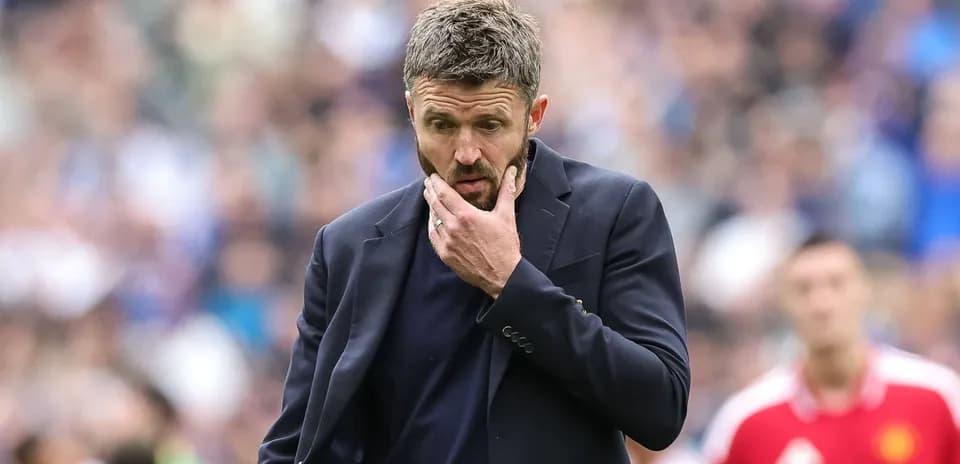Coach contemplating during a football match