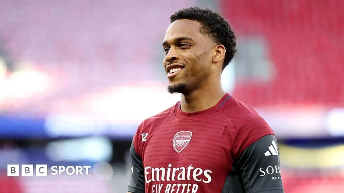 Player smiling in Arsenal training kit before match