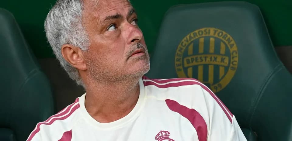 Coach sitting on bench during match preparation