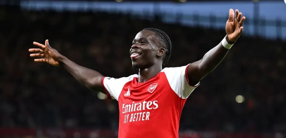 Arsenal player celebrating with arms raised