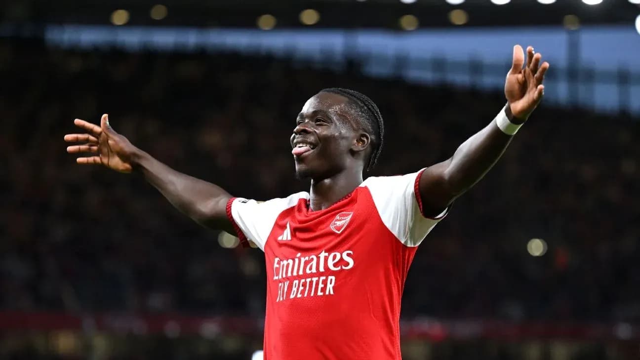 Arsenal player celebrating with arms raised