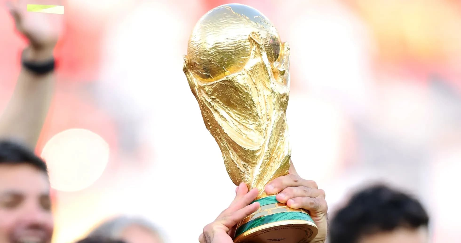 Golden FIFA World Cup trophy held aloft