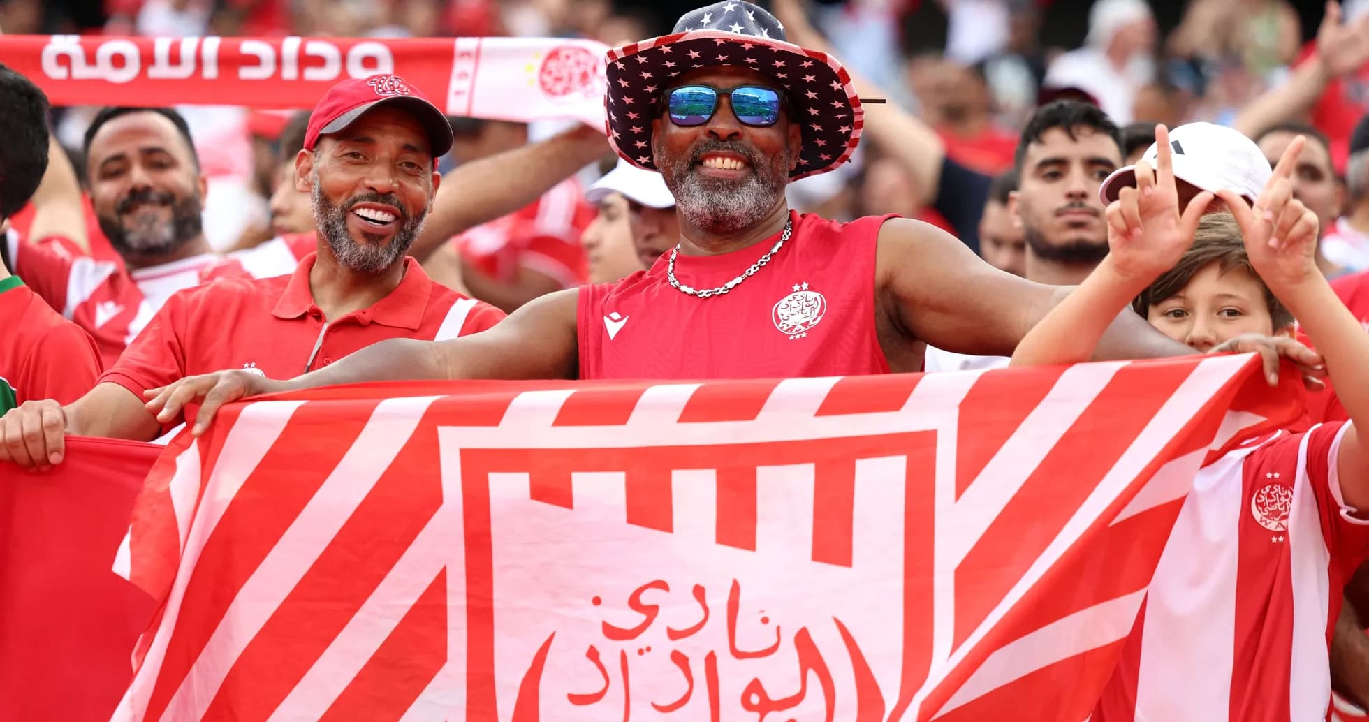 Fans celebrating with club flags at a match