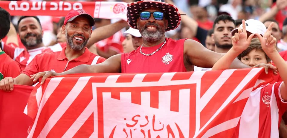 Fans celebrating with club flags at a match