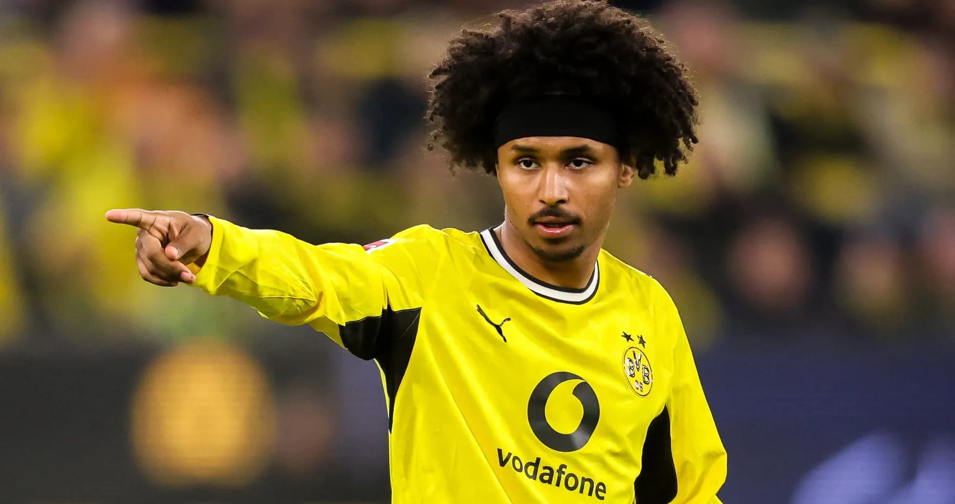 Player pointing during a match in yellow kit