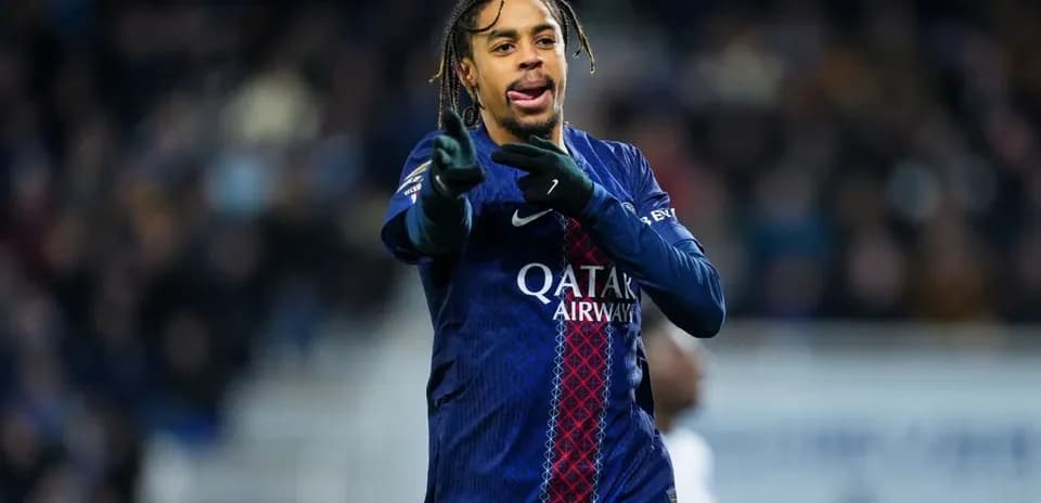 Player gesturing during match wearing PSG jersey