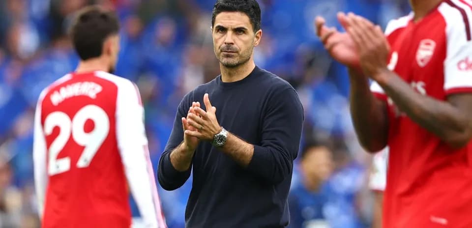 Arsenal manager clapping on the sidelines during match