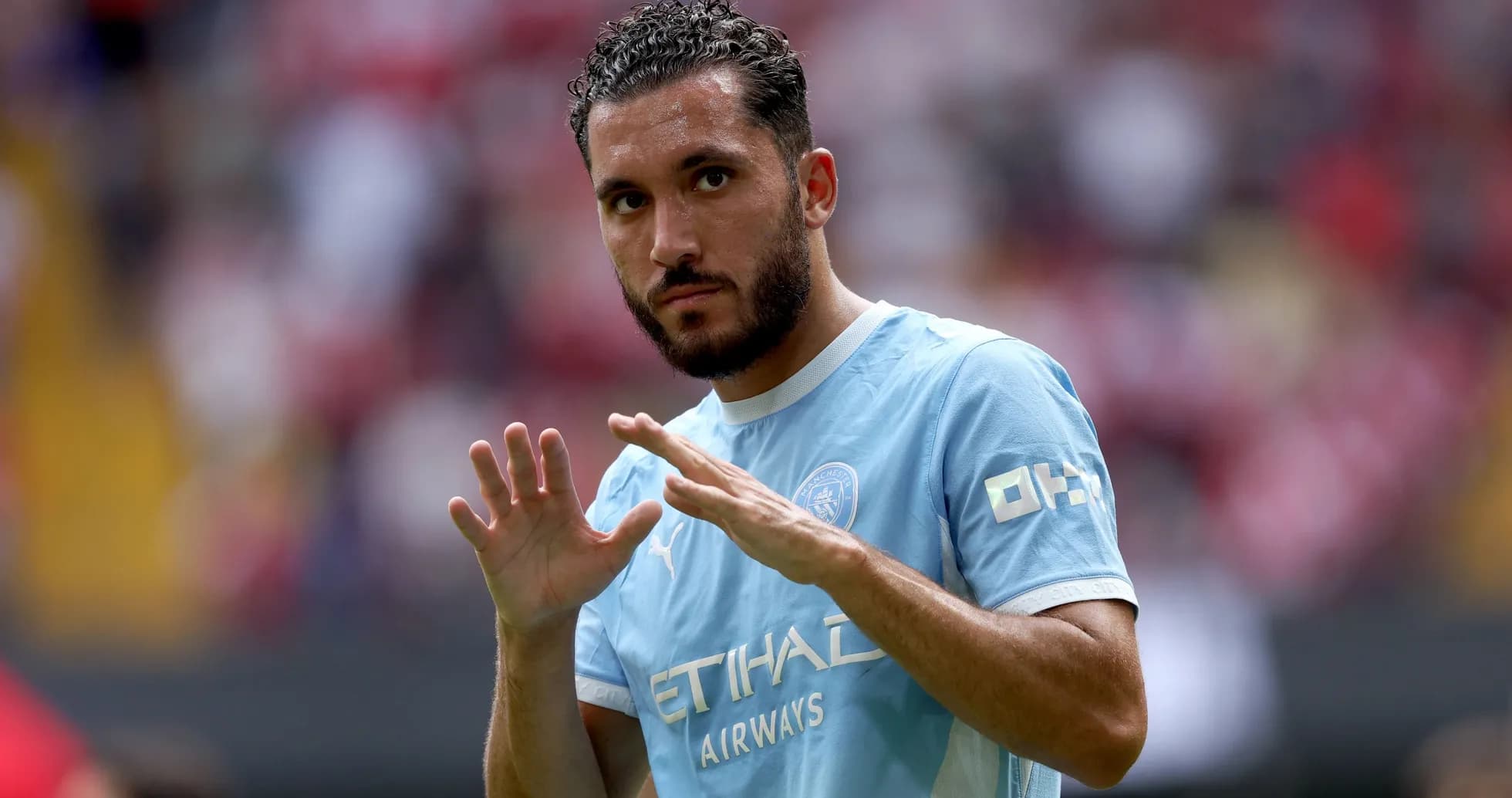 Player gesturing during warm-up in blue jersey
