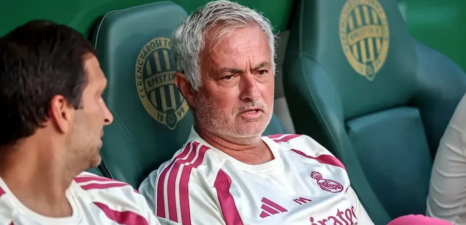 Coaches seated on bench during match