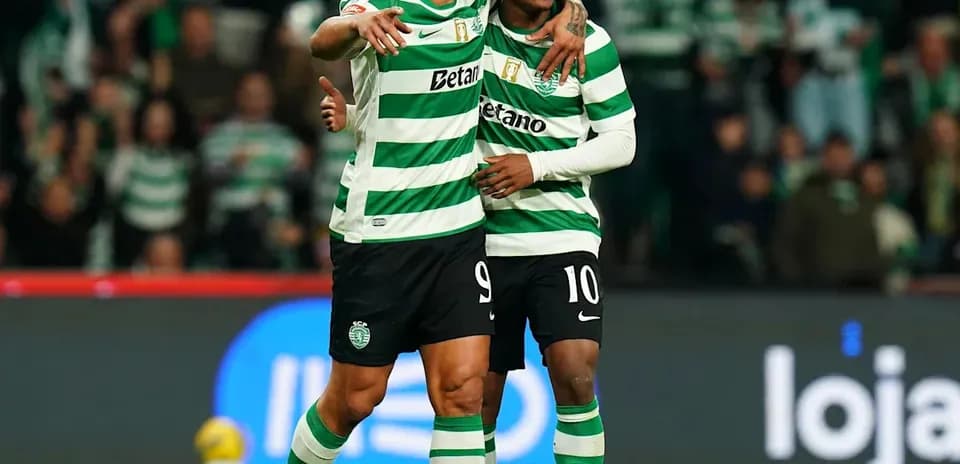 Two players celebrating a goal on the pitch