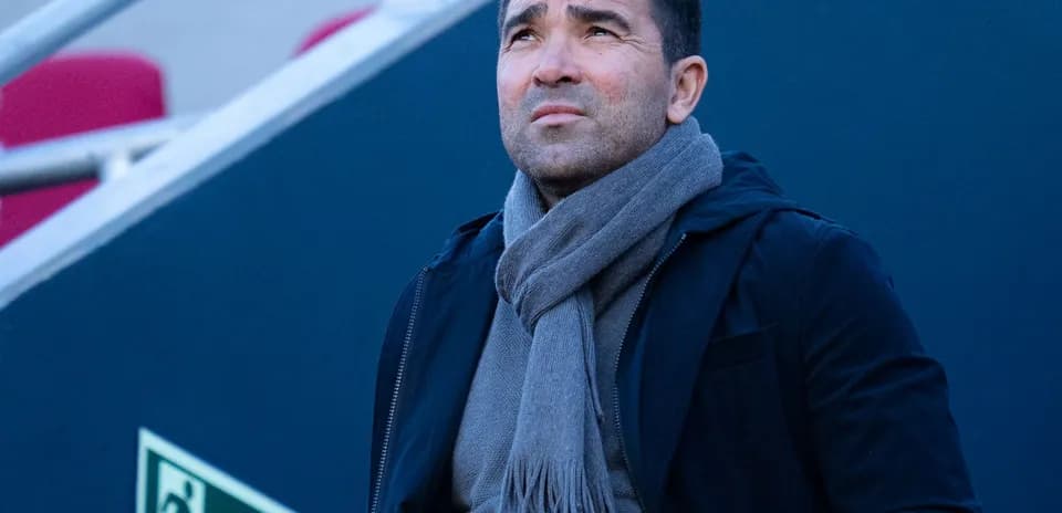 Man looking up, wearing a scarf and jacket